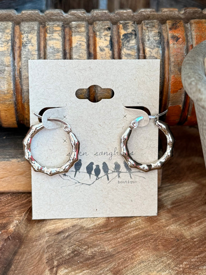 Silver textured hoop earrings on backing card, stainless steel round hoops