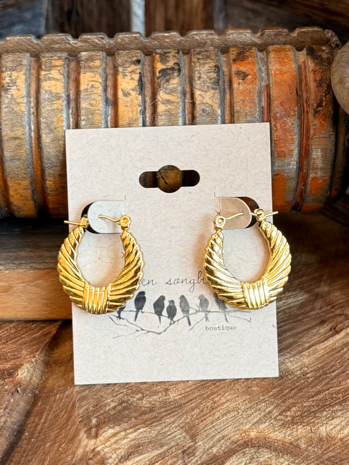 Gold-tone textured half hoop earrings with scalloped edges, shown on display card
