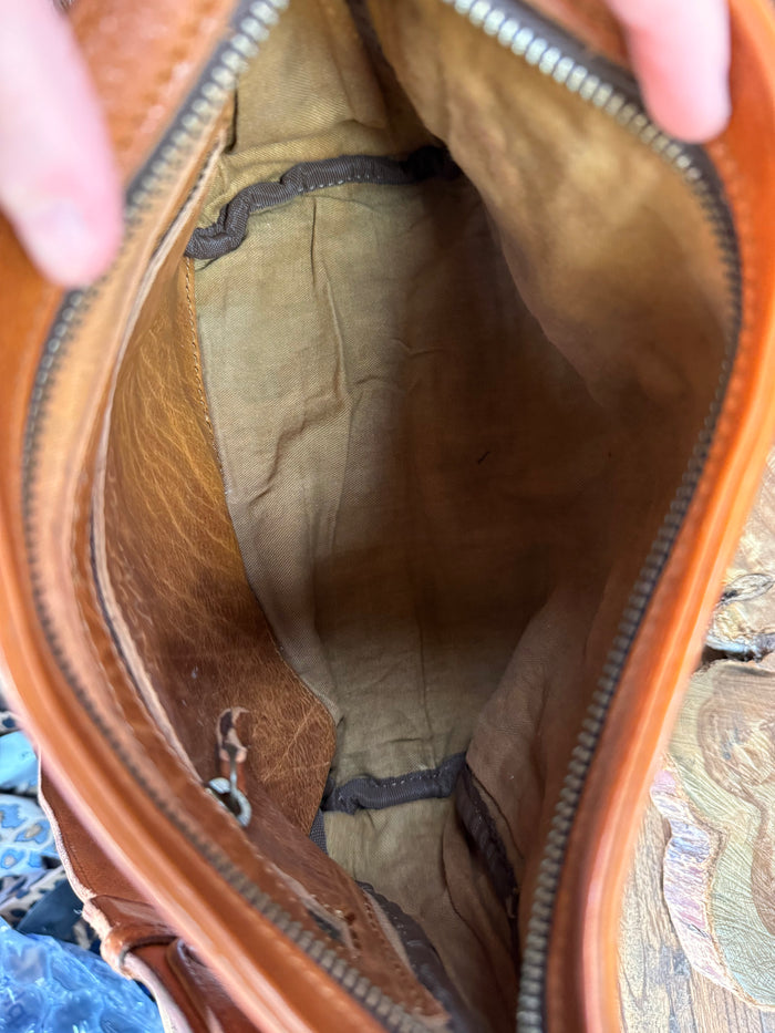 Cognac leather crossbody purse interior with tan fabric lining and stitching
