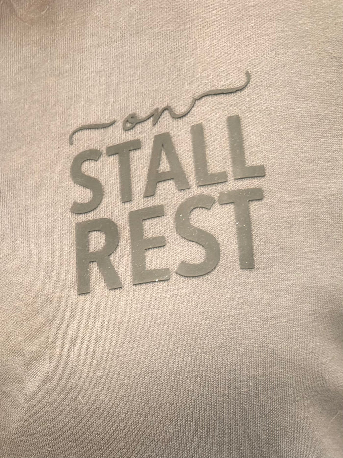 Gray sweatshirt chest graphic: 'STALL REST' in block and script