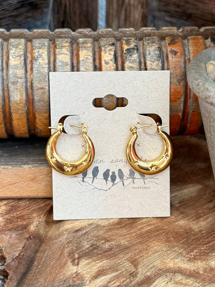 Gold-tone crescent stud earrings with star accents, round hoop style