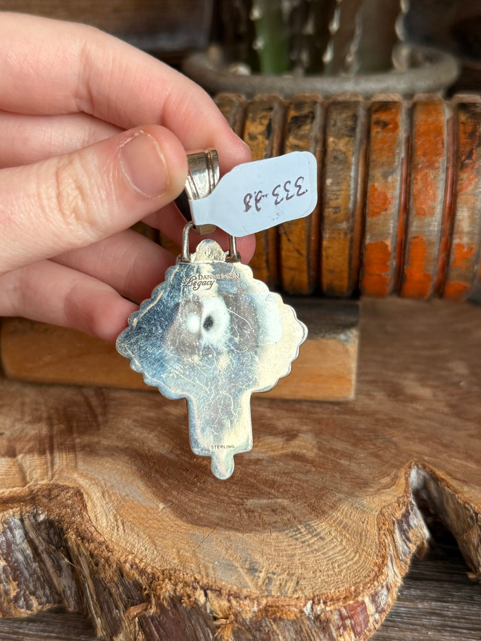Sterling silver cross pendant with wild horse jasper inlaid center held in hand