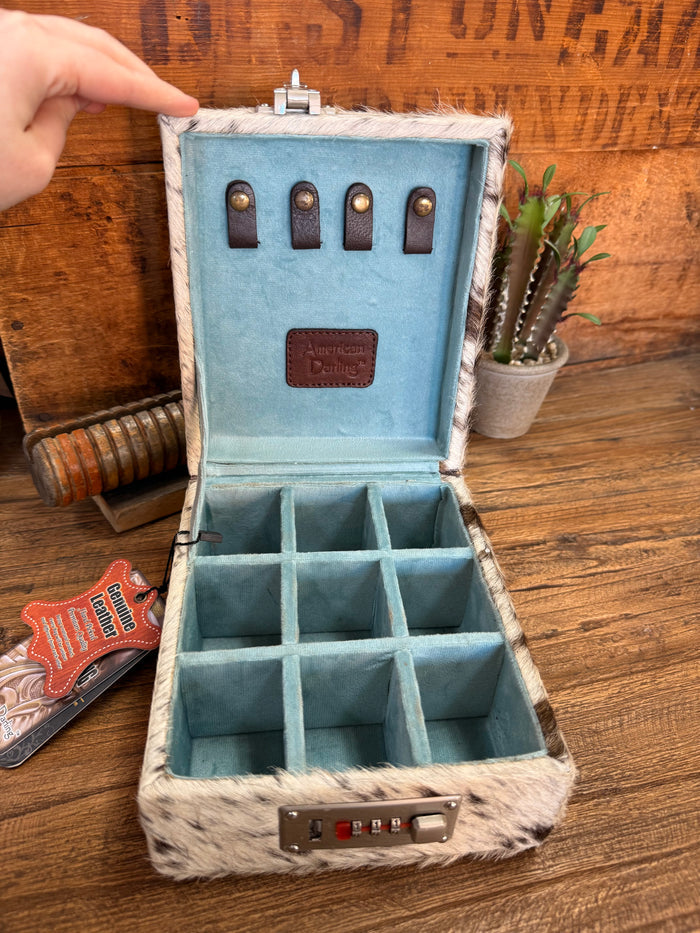 Opened jewelry box with blue tray and ring-slot compartments, lined with hair-on fur