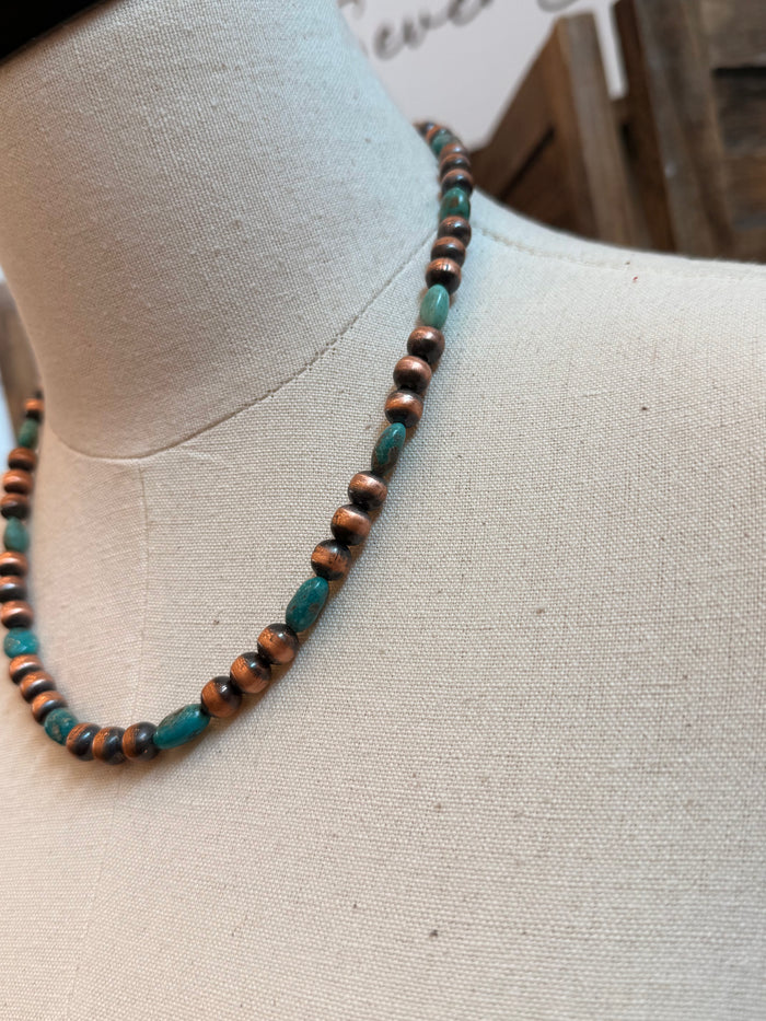 Close-up of copper and turquoise bead necklace with metal bead connectors