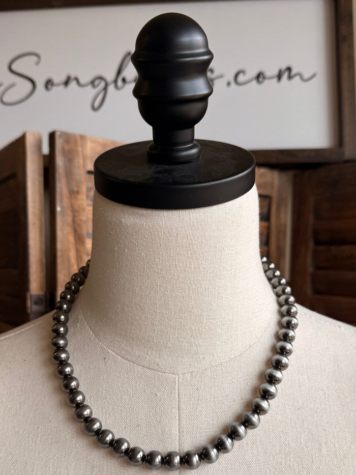 Silver pearl beaded necklace on mannequin, round beads, 18-inch length