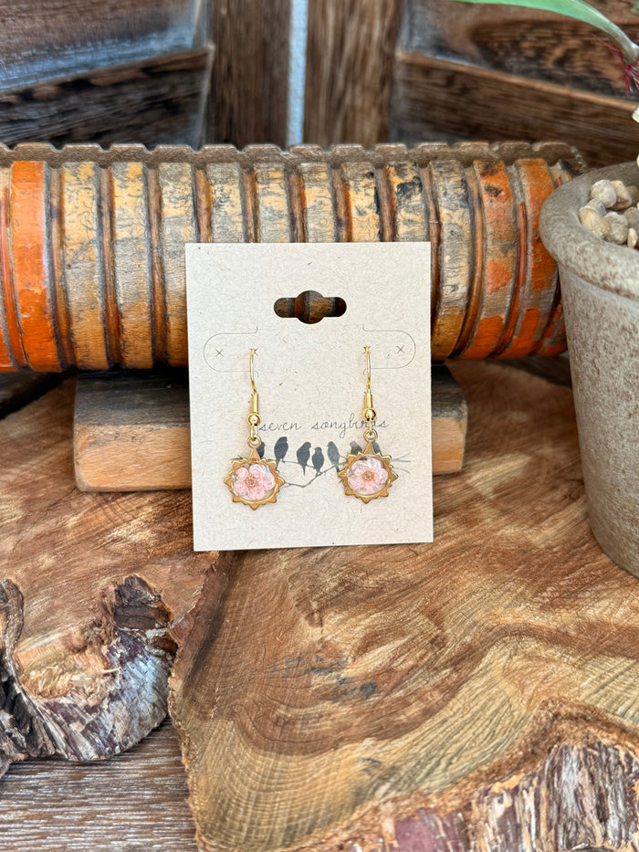 Pink dried flower dangle fishhook earrings with gold-tone hooks and floral charms