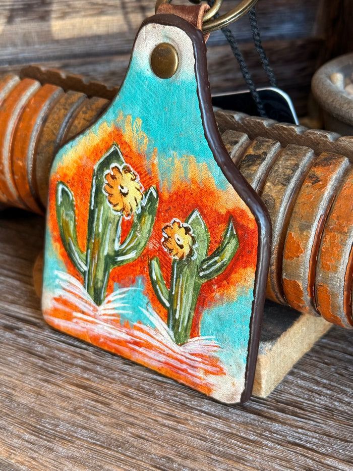 Turquoise cactus leather keychain with two cacti in front, brass ring and chain loop