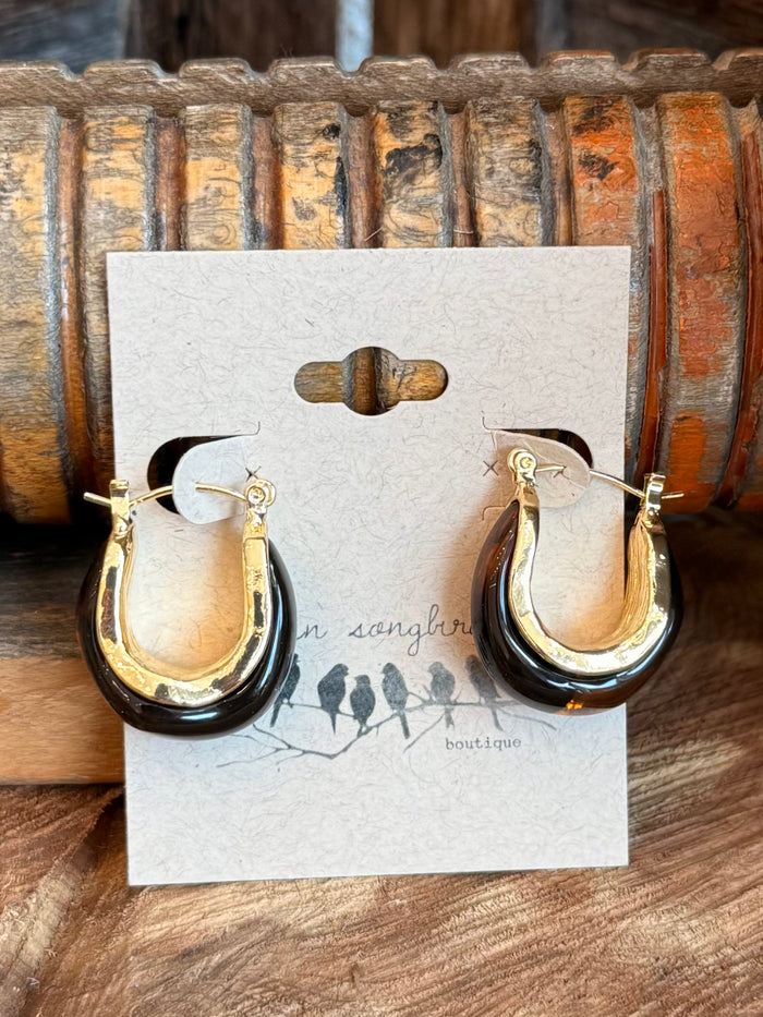 Gold-tone teardrop hoop earrings with small top detail, shown front on card