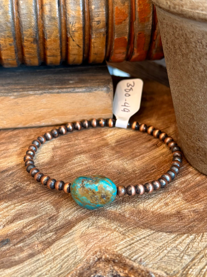 Copper bead stretch bracelet with turquoise oval charm centerpiece detail