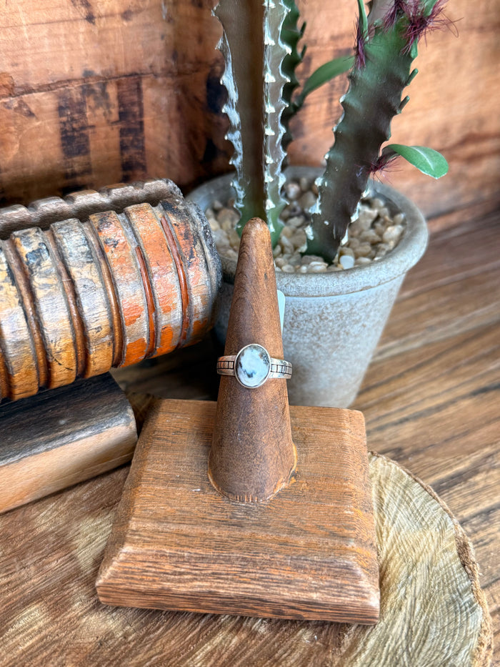 Sterling silver ring with round light blue stone and slim band