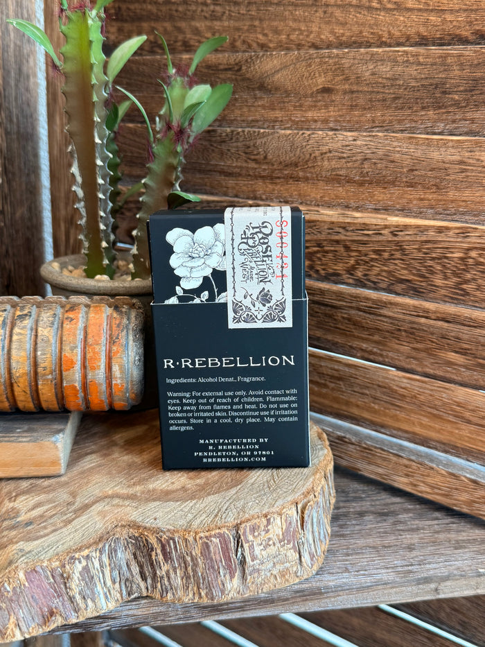 Dark blue perfume box back panel with flower illustration and product description text