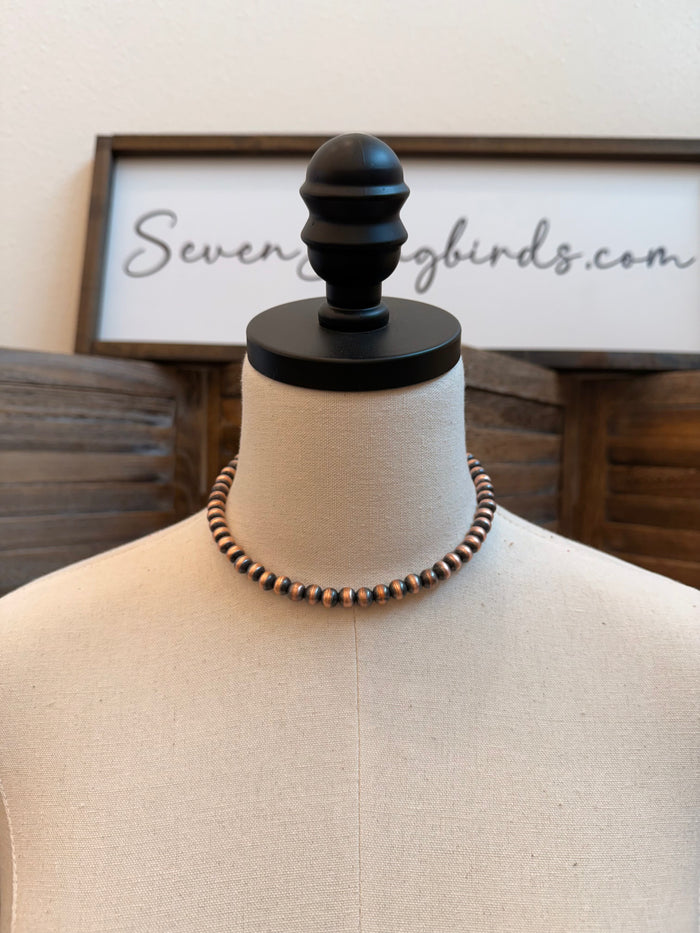 8mm genuine copper bead necklace on black display stand