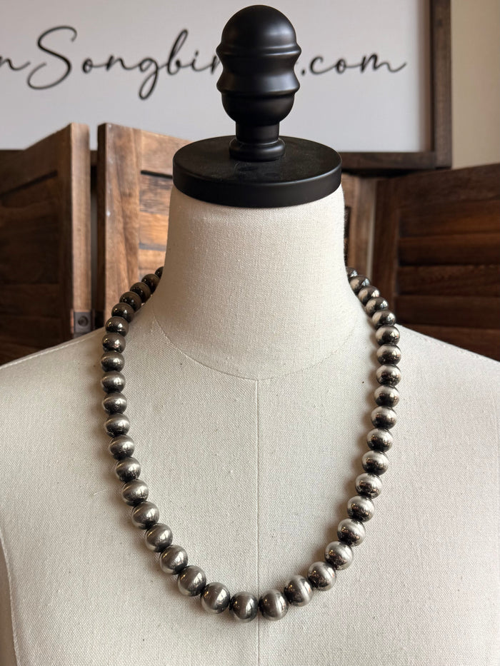 Graduated silver pearl necklace, full strand view on mannequin