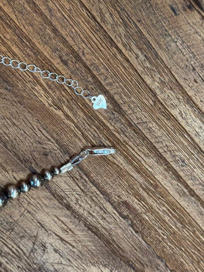Turquoise and orange bead necklace clasp with oval link chain and small hanging charm