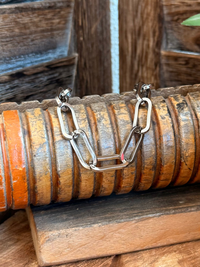 Silver clasp bracelet with oval links and small multicolor stones