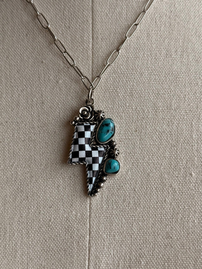 Checkered lightning bolt pendant necklace with turquoise cabochons on silver chain
