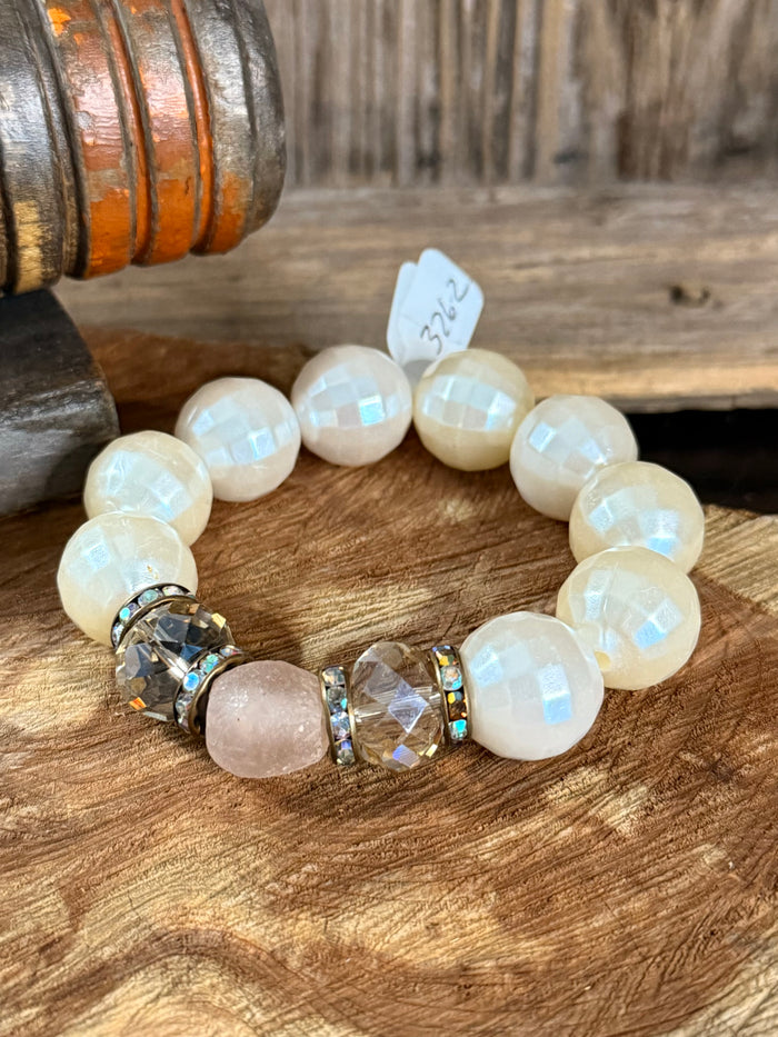 Round opal-like bead stretch bracelet with rose quartz center and faceted crystal links