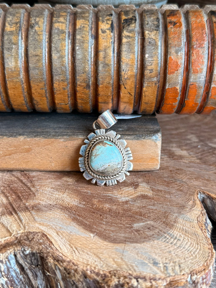 Sterling silver turquoise pendant with round blue cabochon and sunburst bezel