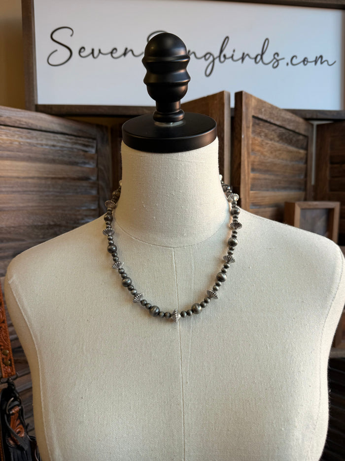 Silver pearl rondelle necklace with graduated beads, centered on mannequin