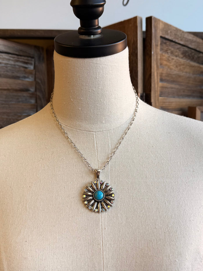 Silver-tone chain necklace with turquoise center crystal flower pendant