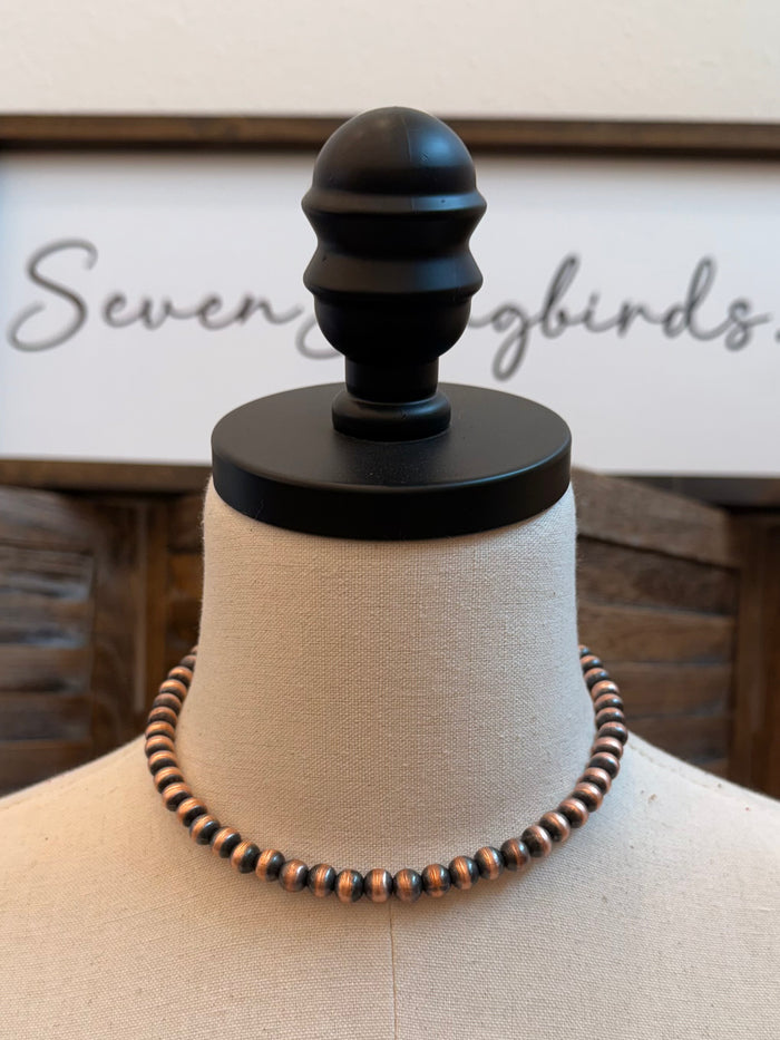 Genuine copper bead necklace with evenly spaced beads on mannequin