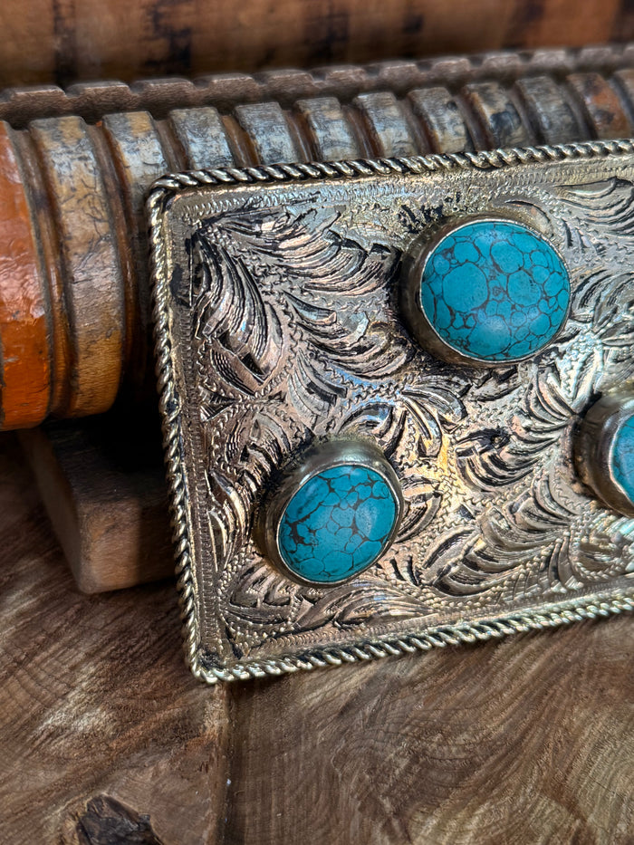 Engraved rectangular belt buckle with three turquoise inlay stones, braided edge detail