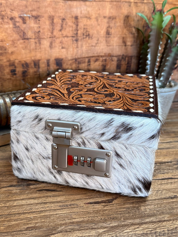 Gray-and-black hair-on jewelry box with metal latch and carved brown leather lid