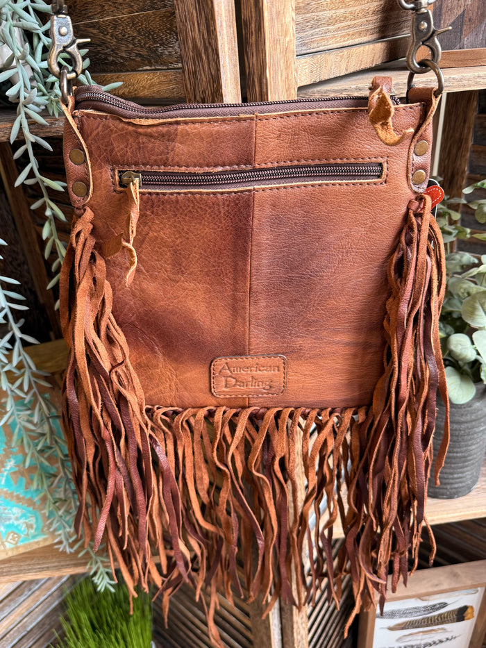 Fringed cowhide coin crossbody purse back, embossed 'American Trading' logo patch