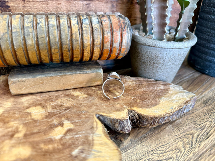 Adjustable open band ring with silver-toned metal, oval setting without visible stone