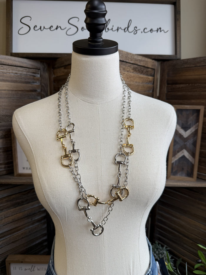 Two-tone triple snaffle bit necklace with linked rings and long chain