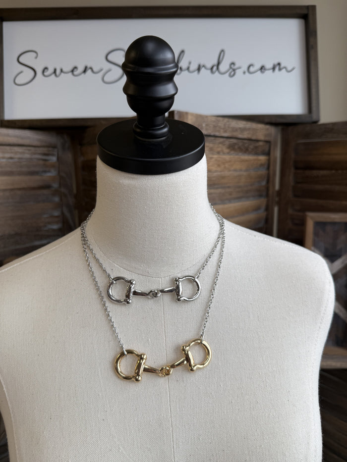 Snaffle bit necklace with mixed gold- and silver-tone D-ring charms on chain