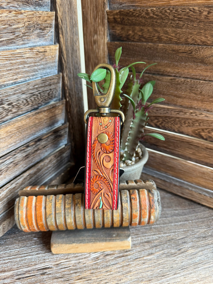 Tooled leather sunflower keychain with bronze clasp and red embossed floral panel