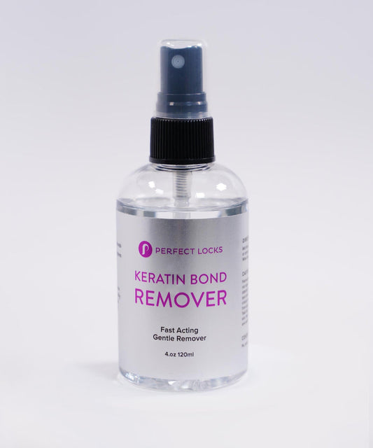 A clear spray bottle labeled Perfect Locks Keratin Bond Remover with a black spray top, holding 4 oz, set on a white background.