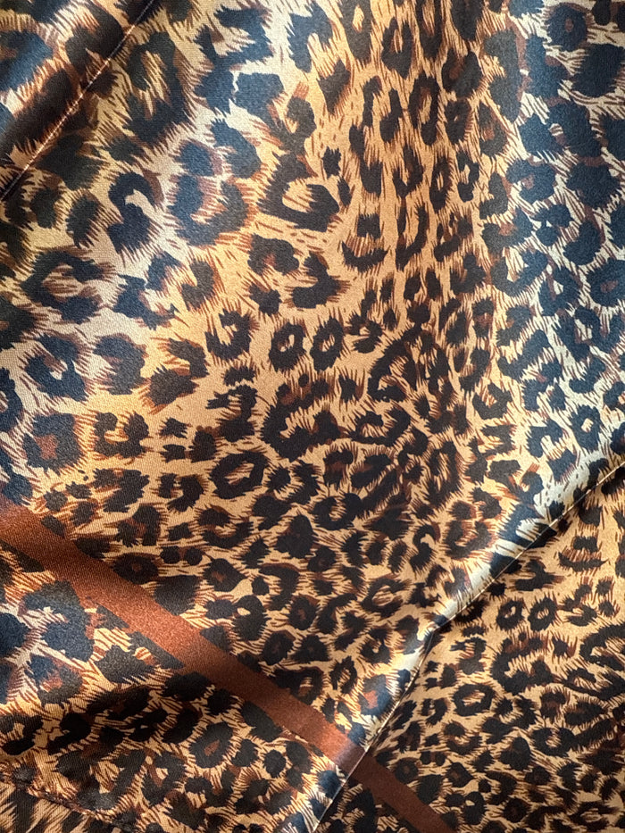 Leopard print wild rag scarf fabric close-up with brown, black, and cream tones