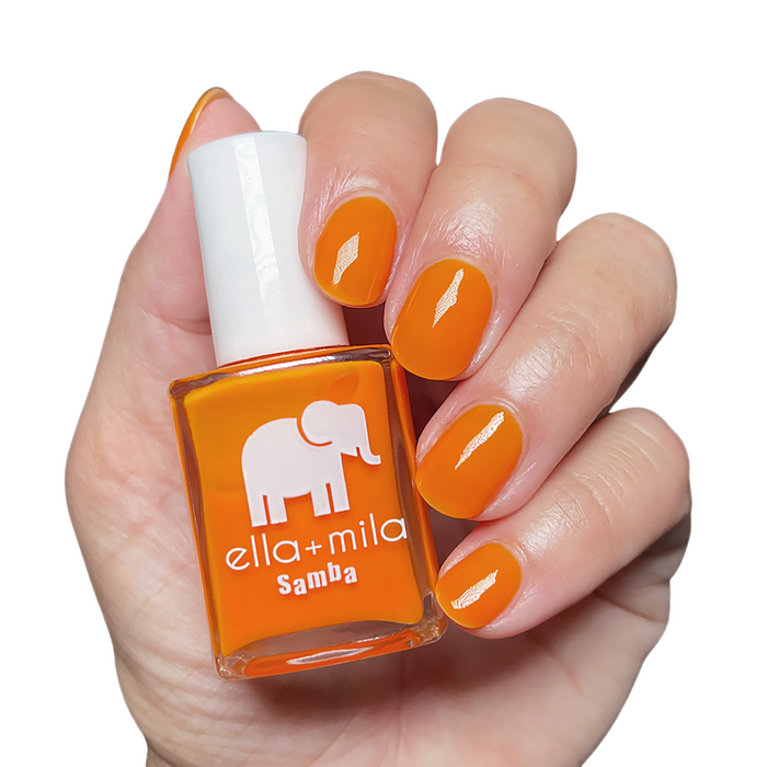 Aperol Spritz vivid orange nail polish manicure on a light skin tone with the bottle