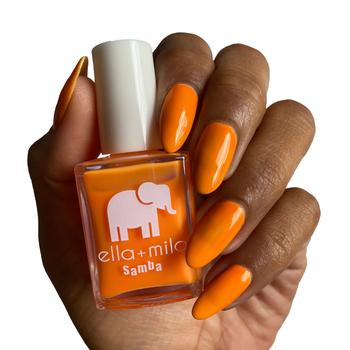 Aperol Spritz neon orange nail polish on a deep skin tone, hand holding the bottle
