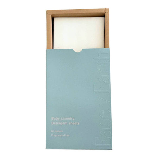 Box of baby laundry detergent sheets with a white sheet inside on a white background.