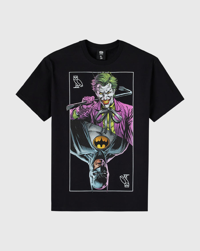 Black t-shirt with mirrored graphic of Batman and Joker characters, yellow bat logo in center.