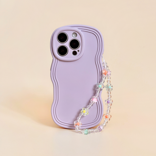 Lavender phone case with wavy edges and a beaded strap featuring colorful flower beads, shown on a beige background.