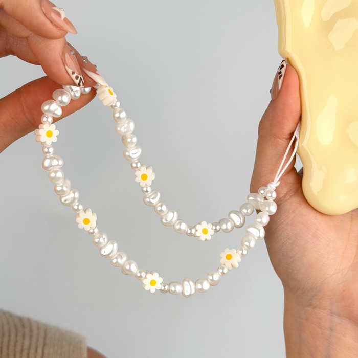 close up of daisy pearl phone strap
