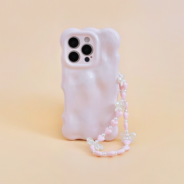 Pastel pink wavy phone case with attached beaded strap featuring heart and bow beads.
