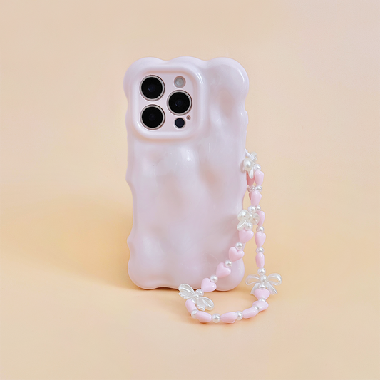 Pastel pink wavy phone case with attached beaded strap featuring heart and bow beads.