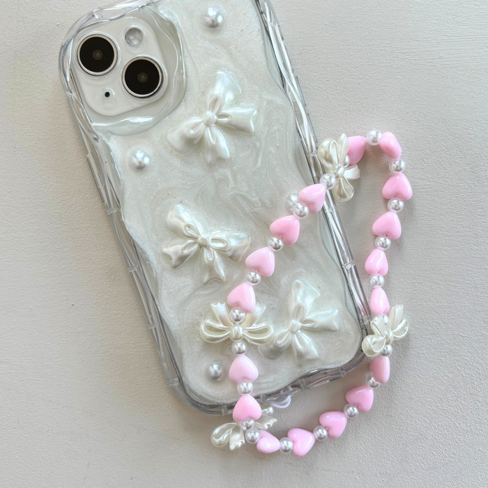 Coconut Lane beaded phone strap with pink hearts, white pearls, and small bow charms.