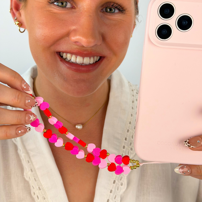 Girl smiling with her hearts phone strap