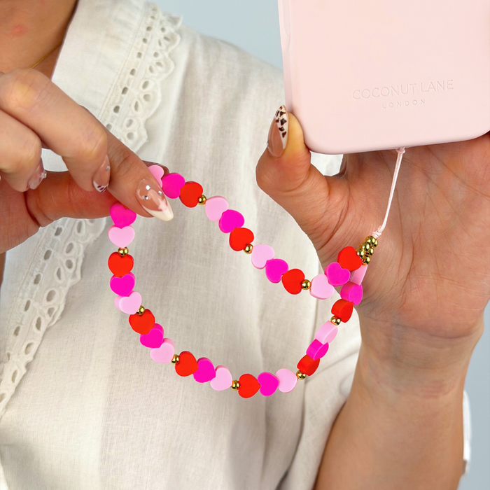 hearts phone strap attached to phone case - pink, red and gold gems