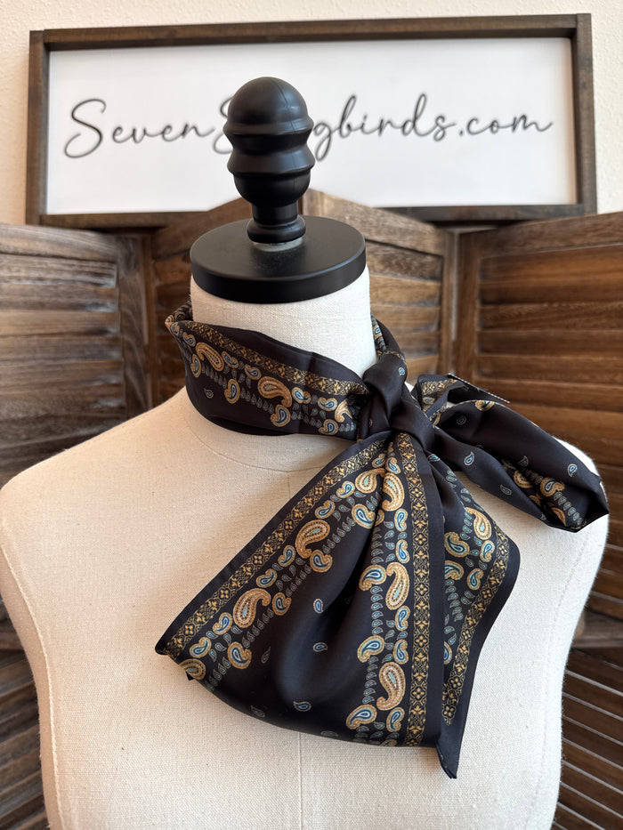 Black paisley twilly scarf with gold trim, tied bow on mannequin neck