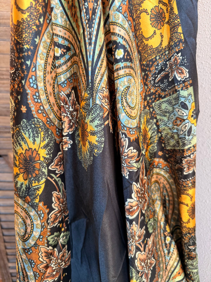 Wild rag scarf with black base and gold, orange, teal paisley floral print