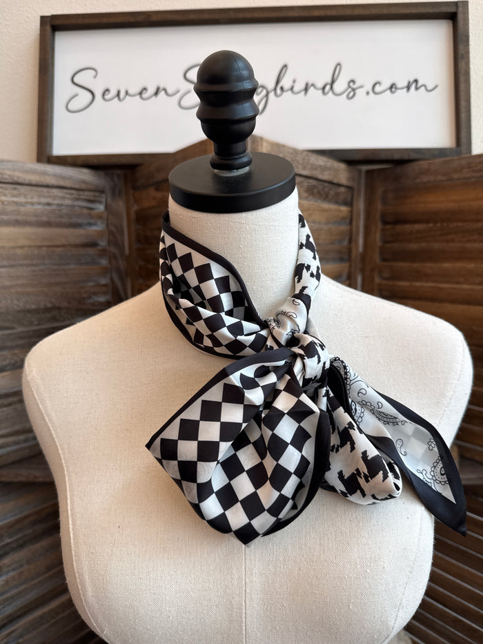 Black-and-white checkered twilly scarf tied in a bow