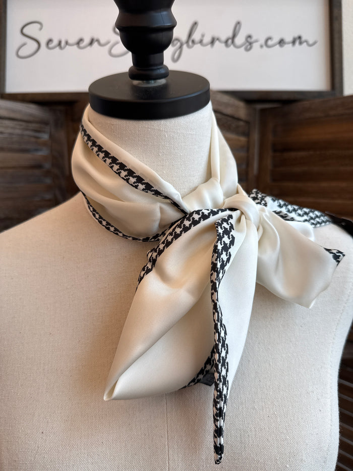 Black and white herringbone twilly scarf tied in a bow on a mannequin