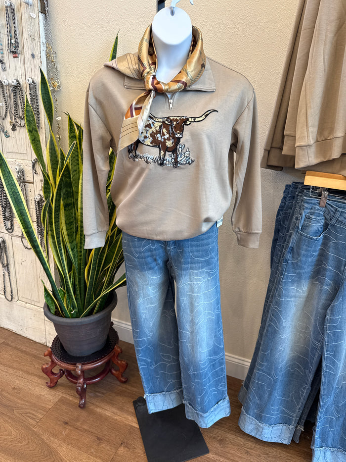 Light blue cuffed jeans with allover stitched line pattern, worn with top and scarf